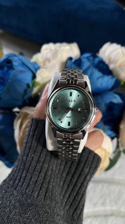 Montre Baby Blue unisexe avec cadran bleu rond et bracelet argenté en acier inoxydable sur fond bleu